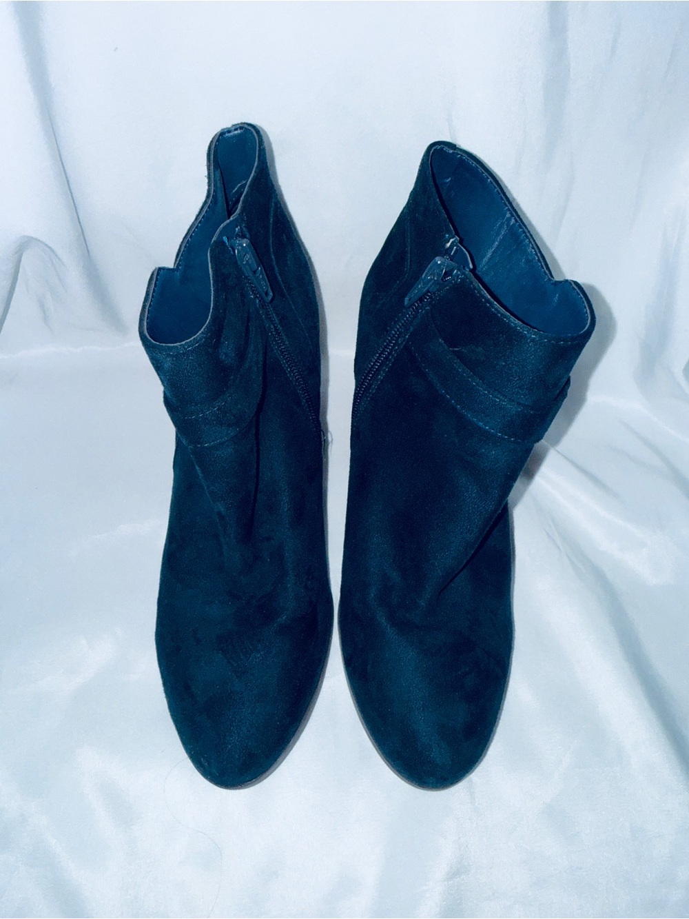 Woman’s blue ankle heeled boots zip up